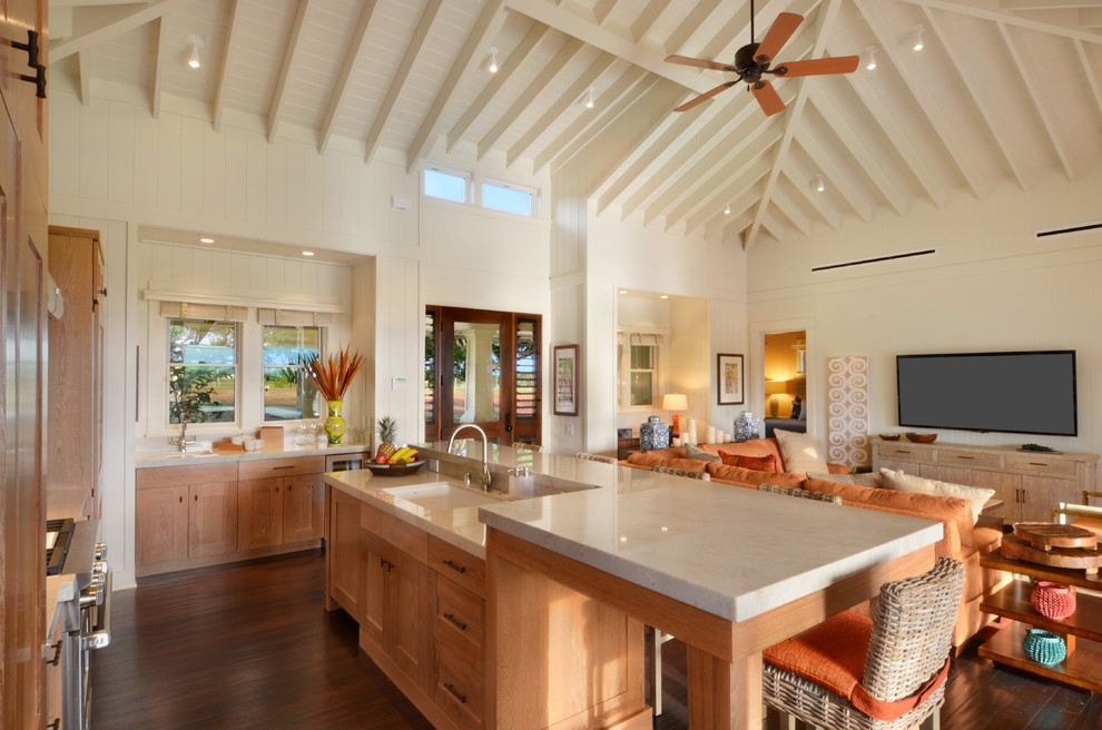 Photo of a tropical l-shaped open plan kitchen in Hawaii with an undermount sink, shaker cabinets, medium wood cabinets, dark hardwood floors and with island.