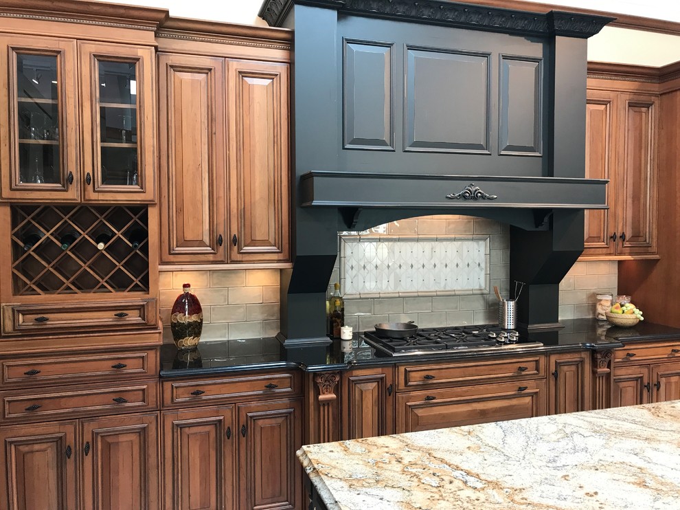 Design ideas for a large traditional single-wall kitchen pantry in St Louis with raised-panel cabinets, distressed cabinets, granite benchtops, beige splashback, marble splashback, stainless steel appliances, porcelain floors, with island and beige floor.