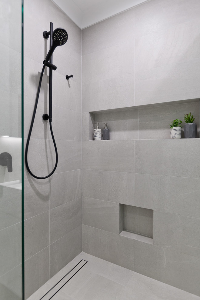 Design ideas for a small contemporary 3/4 bathroom in Perth with flat-panel cabinets, white cabinets, a two-piece toilet, beige tile, porcelain tile, beige walls, porcelain floors, an integrated sink, solid surface benchtops, beige floor, a sliding shower screen and white benchtops.