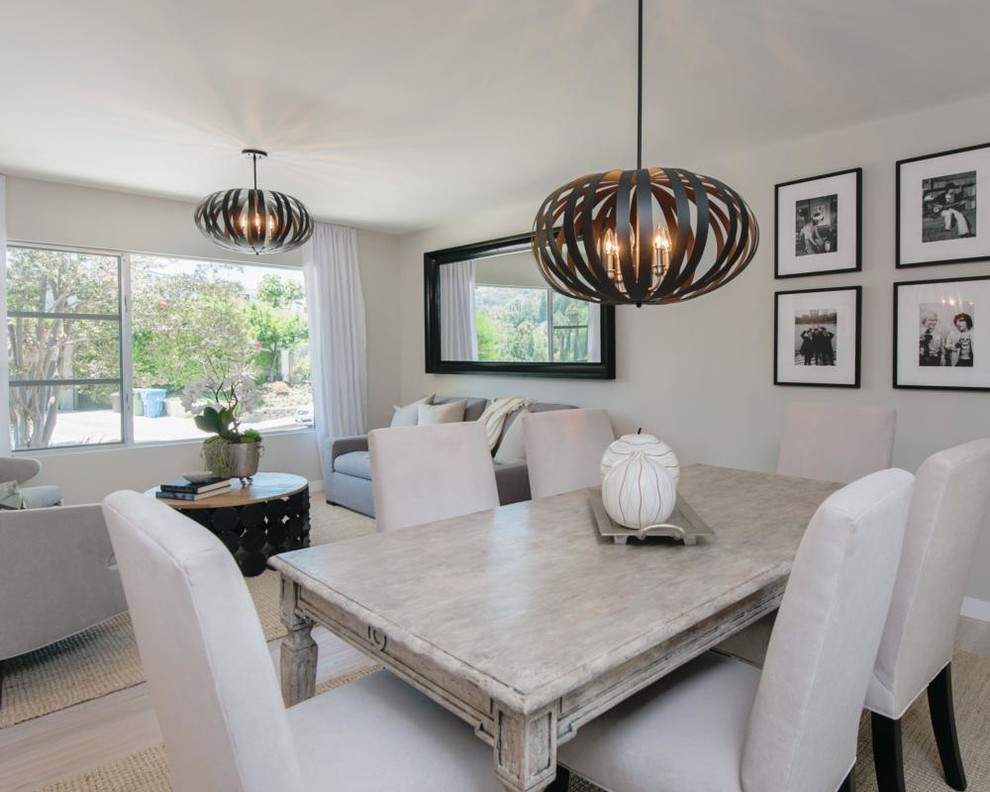 Mid-sized transitional open plan dining in Other with grey walls, light hardwood floors and no fireplace.