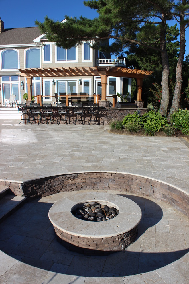 Photo of a beach style patio in New York with brick pavers.