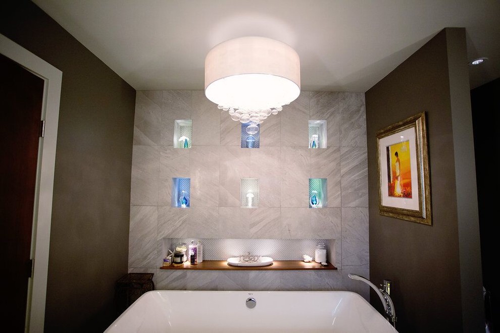 Design ideas for a mid-sized modern master bathroom in Vancouver with an integrated sink, a freestanding tub, a one-piece toilet, gray tile, porcelain tile, grey walls and porcelain floors.