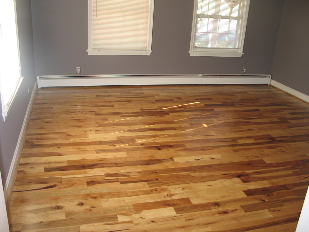 Example of a mountain style light wood floor home design design with no fireplace and purple walls