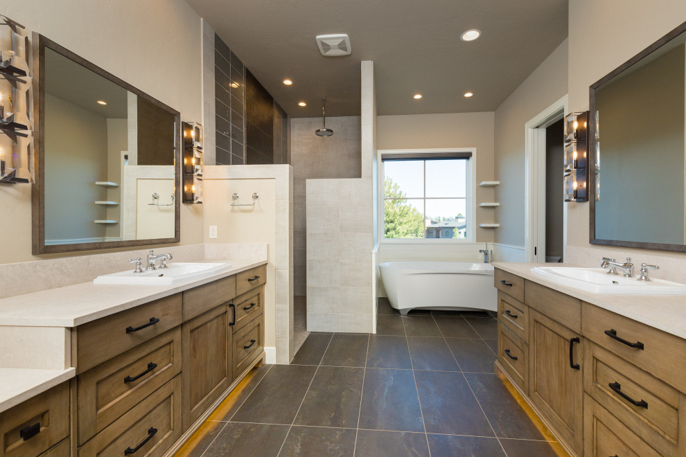 This is an example of a large country master bathroom in Other with shaker cabinets, distressed cabinets, a freestanding tub, a curbless shower, gray tile, ceramic tile, ceramic floors, engineered quartz benchtops, grey floor, an open shower, beige benchtops, a double vanity and a built-in vanity.