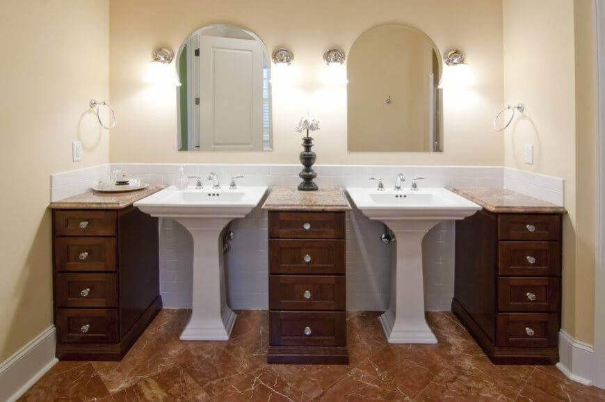 This is an example of a mid-sized traditional master bathroom in Other with recessed-panel cabinets, dark wood cabinets, yellow walls, marble floors, a pedestal sink, granite benchtops and brown floor.