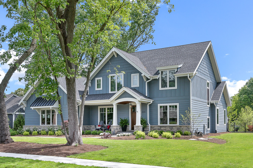 Inspiration for a large arts and crafts two-storey blue house exterior in Chicago with a gable roof, a shingle roof, wood siding, board and batten siding, clapboard siding and shingle siding.