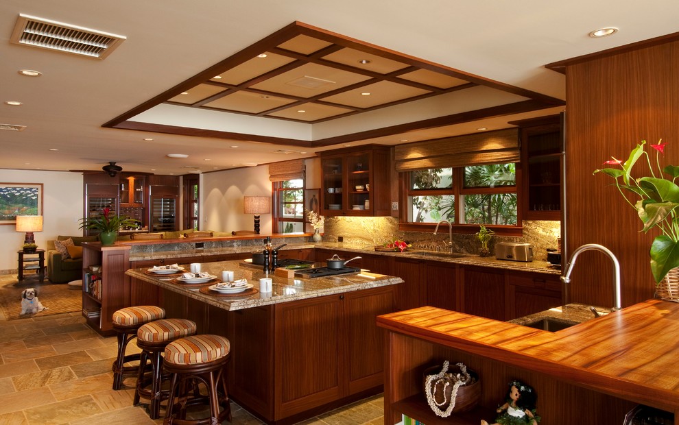 Large tropical u-shaped eat-in kitchen in Hawaii with an undermount sink, shaker cabinets, medium wood cabinets, granite benchtops, stainless steel appliances, ceramic floors and with island.