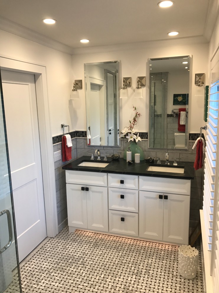 Inspiration for a small traditional master bathroom in Indianapolis with recessed-panel cabinets, white cabinets, gray tile, white walls, marble floors, an undermount sink, solid surface benchtops, grey floor and a hinged shower door.