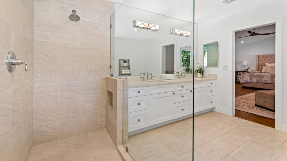 Huge transitional master white tile and porcelain tile porcelain tile and beige floor bathroom photo in Los Angeles with a wall-mount toilet, white walls, an undermount sink, quartzite countertops and beige countertops
