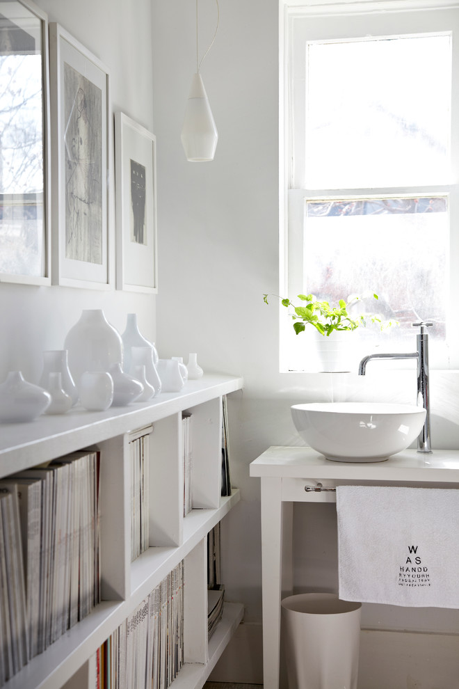 Inspiration for a contemporary powder room in Toronto with a vessel sink, furniture-like cabinets, white cabinets and white walls.