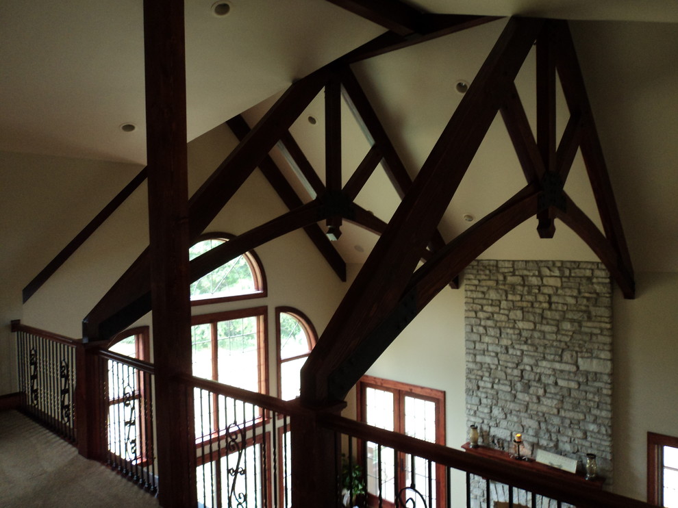 Inspiration for a mid-sized rustic carpeted and brown floor hallway remodel in Chicago with gray walls
