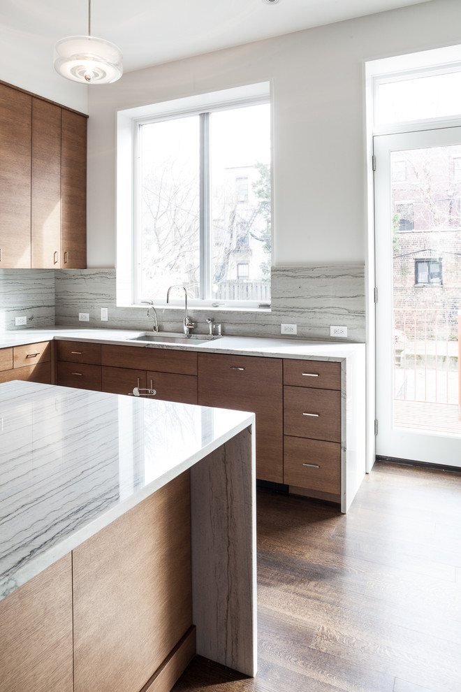 Design ideas for a mid-sized modern u-shaped eat-in kitchen in New York with an undermount sink, flat-panel cabinets, dark wood cabinets, marble benchtops, grey splashback, stone slab splashback, stainless steel appliances, dark hardwood floors, with island and brown floor.