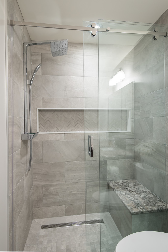 Contemporary master bathroom in Toronto with dark wood cabinets, a curbless shower, a one-piece toilet, gray tile, stone tile, grey walls, porcelain floors, an undermount sink and granite benchtops.