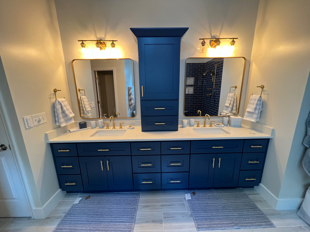Mid-sized transitional master blue tile and porcelain tile porcelain tile, gray floor and double-sink bathroom photo in Atlanta with shaker cabinets, blue cabinets, a two-piece toilet, beige walls, an undermount sink, quartz countertops, a hinged shower door, white countertops, a niche and a built-in vanity