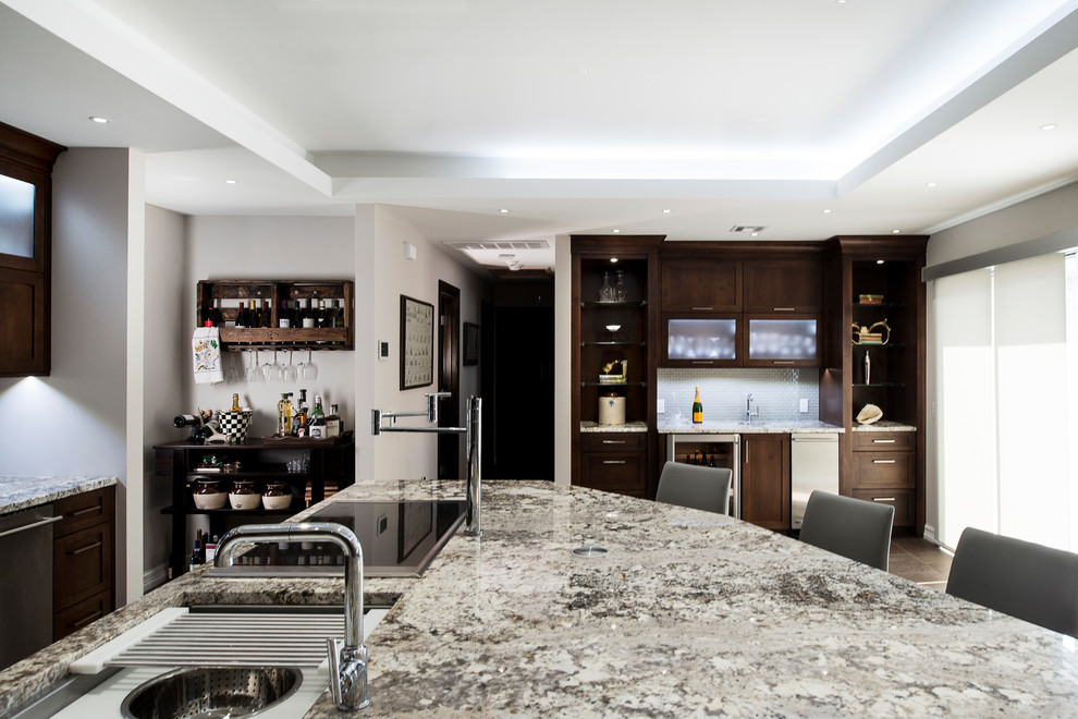Eat-in kitchen - large transitional ceramic tile and beige floor eat-in kitchen idea with an undermount sink, shaker cabinets, brown cabinets, granite countertops, white backsplash, stainless steel appliances, an island and glass tile backsplash