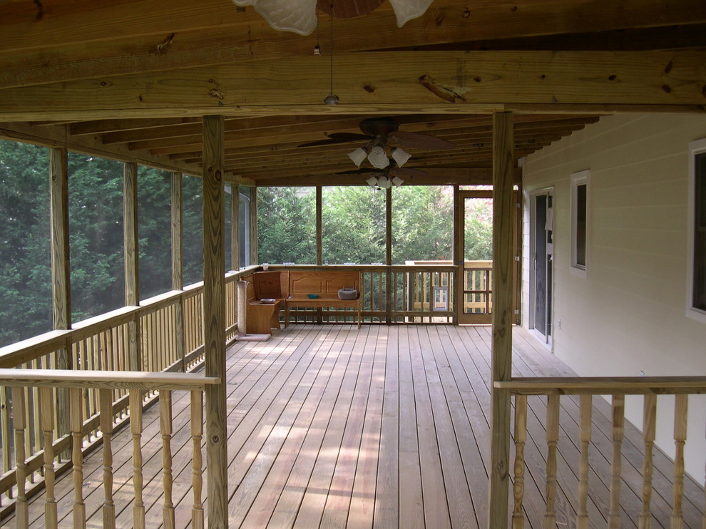 Inspiration for a mid-sized rustic backyard deck remodel in Baltimore with a roof extension