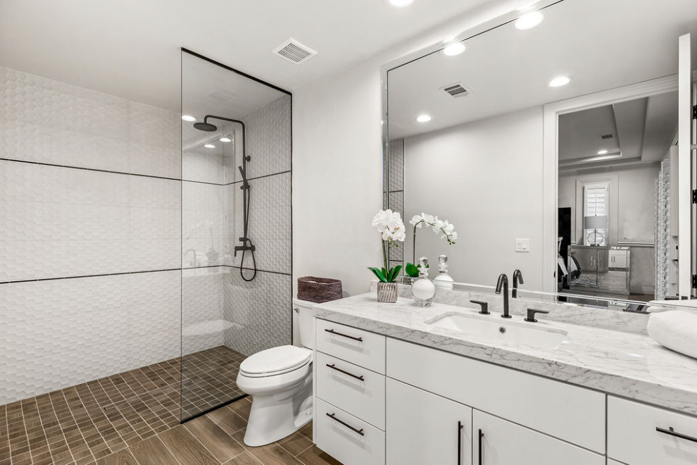 Inspiration for a mid-sized eclectic 3/4 bathroom in Las Vegas with flat-panel cabinets, white cabinets, a two-piece toilet, white tile, ceramic tile, white walls, ceramic floors, an undermount sink, marble benchtops, a hinged shower door, white benchtops, a single vanity and a built-in vanity.