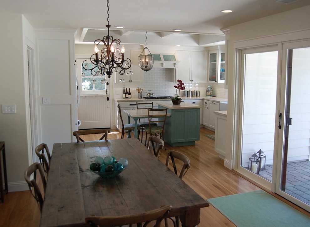 Photo of a mid-sized traditional kitchen/dining combo in Orange County with white walls, light hardwood floors and no fireplace.