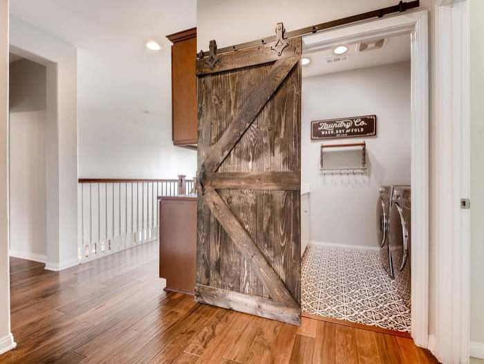 Modern Farmhouse - Modern Farmhouse Laundry Room with sliding barn door with gorgeous black and white Moroccan style tile.