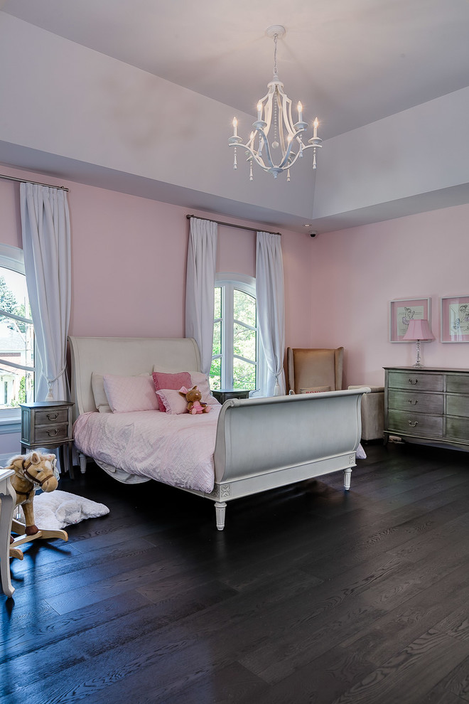 Large transitional kids' bedroom in Toronto with pink walls and dark hardwood floors for kids 4-10 years old and girls.