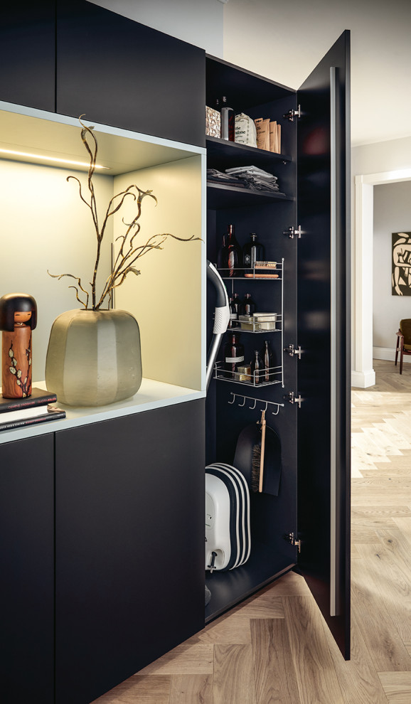 Dressing room - contemporary gender-neutral dressing room idea in Nuremberg with flat-panel cabinets