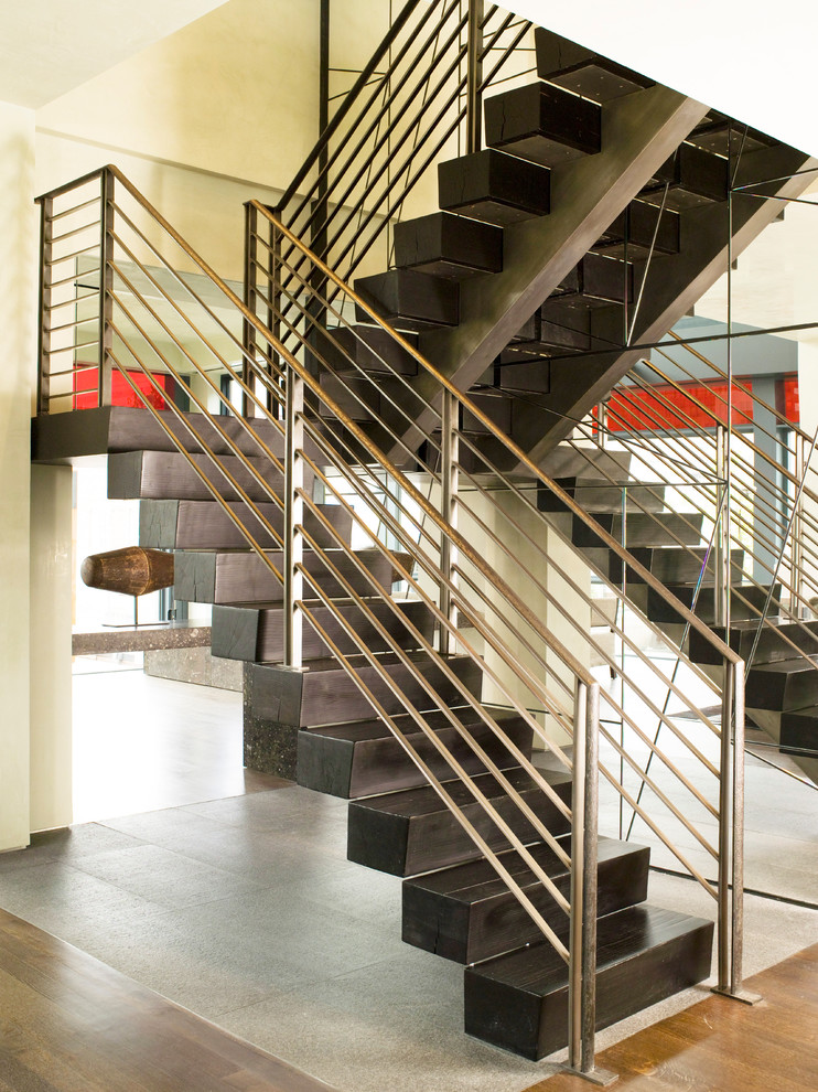 Photo of a contemporary wood u-shaped staircase in New York with wood risers.