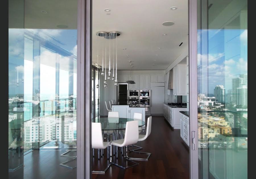 Eat-in kitchen - mid-sized transitional single-wall porcelain tile and beige floor eat-in kitchen idea in Phoenix with an undermount sink, shaker cabinets, white cabinets, marble countertops, metallic backsplash, stainless steel appliances and an island