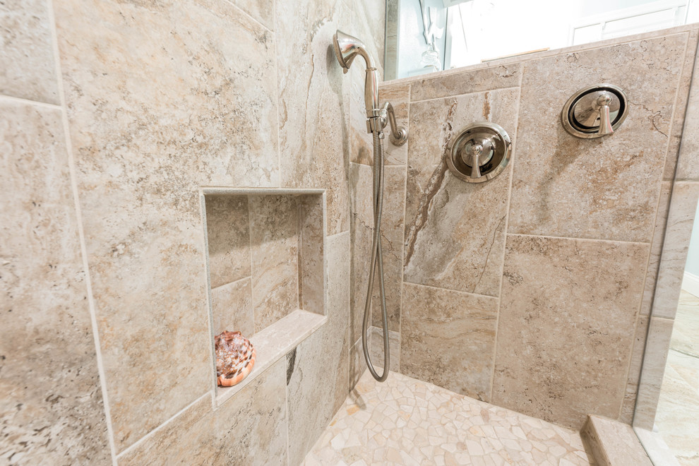 Photo of a large beach style 3/4 bathroom in Other with beaded inset cabinets, white cabinets, a corner shower, beige tile, porcelain tile, blue walls, porcelain floors, an undermount sink, recycled glass benchtops, beige floor and a hinged shower door.