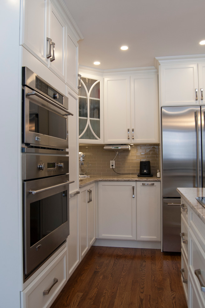 Example of a transitional kitchen design in Ottawa with an island