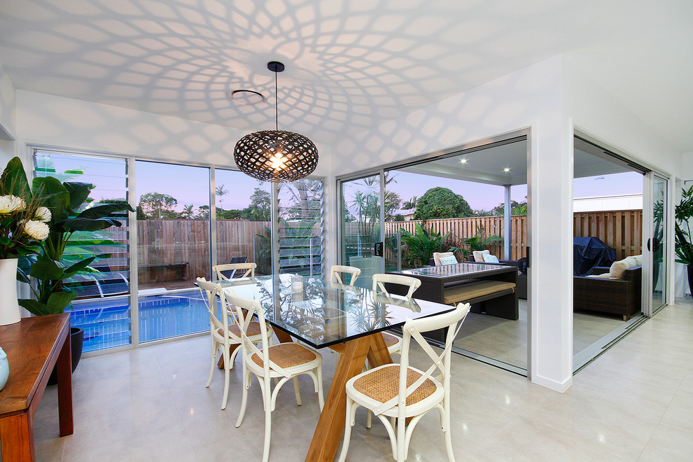 Photo of a beach style dining room in Sunshine Coast with white walls.