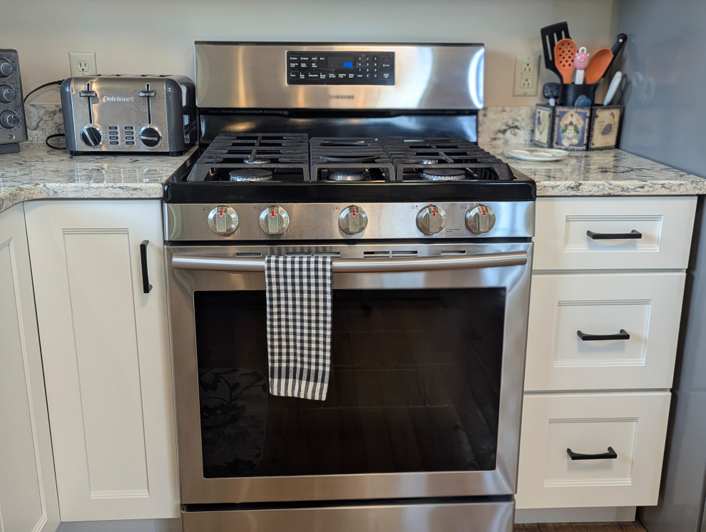 Inspiration for a small transitional u-shaped eat-in kitchen remodel with flat-panel cabinets