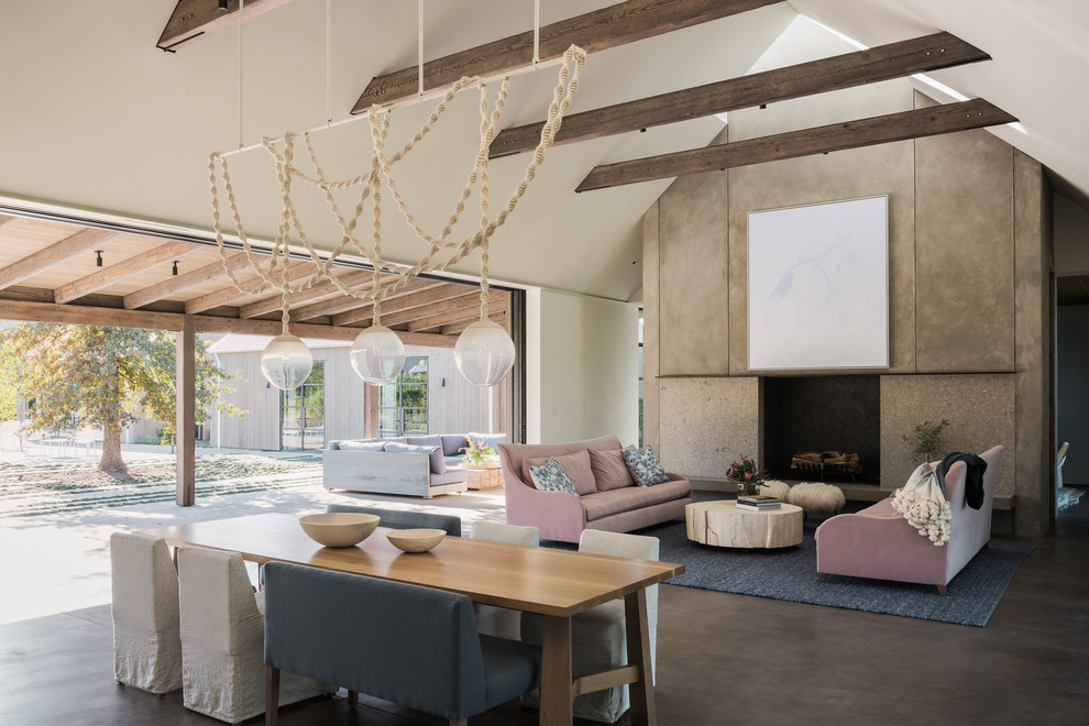 Inspiration for a country open concept living room in San Francisco with concrete floors, a standard fireplace and grey floor.