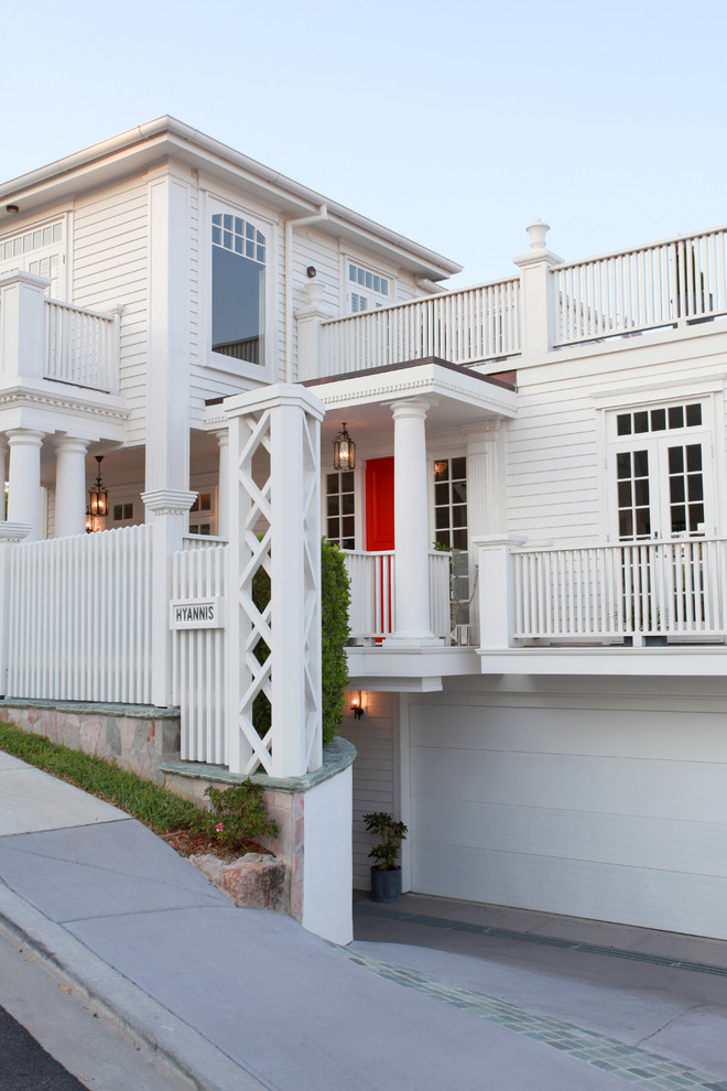 Inspiration for a large traditional two-storey white exterior in Brisbane with wood siding.