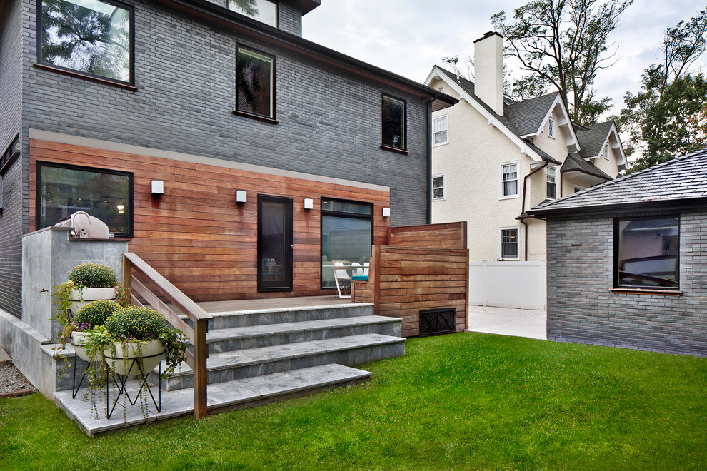 This is an example of a mid-sized contemporary backyard deck in New York with no cover.