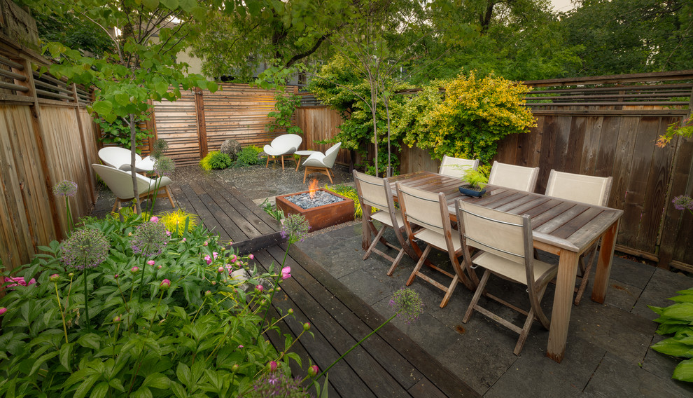 Design ideas for an asian backyard patio in Toronto with a fire feature and decking.