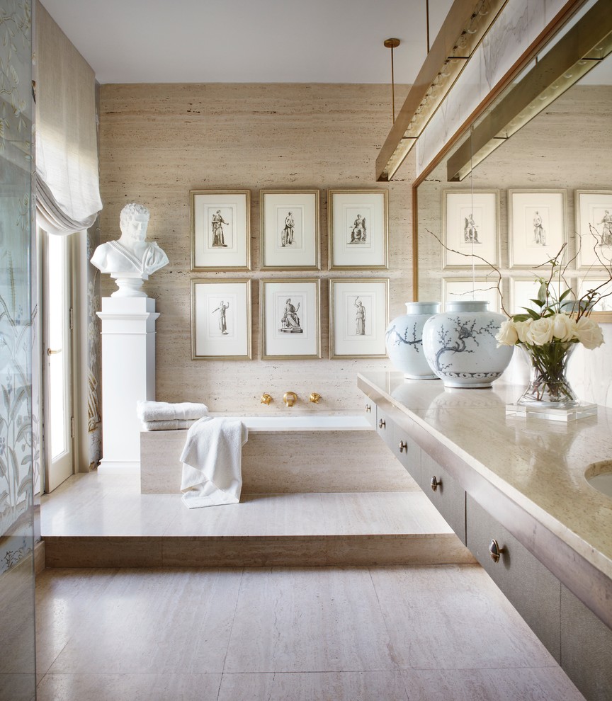 Inspiration for a mid-sized transitional master bathroom in Chicago with an undermount sink, stone slab, flat-panel cabinets, medium wood cabinets, an undermount tub, beige tile, beige walls, porcelain floors and limestone benchtops.