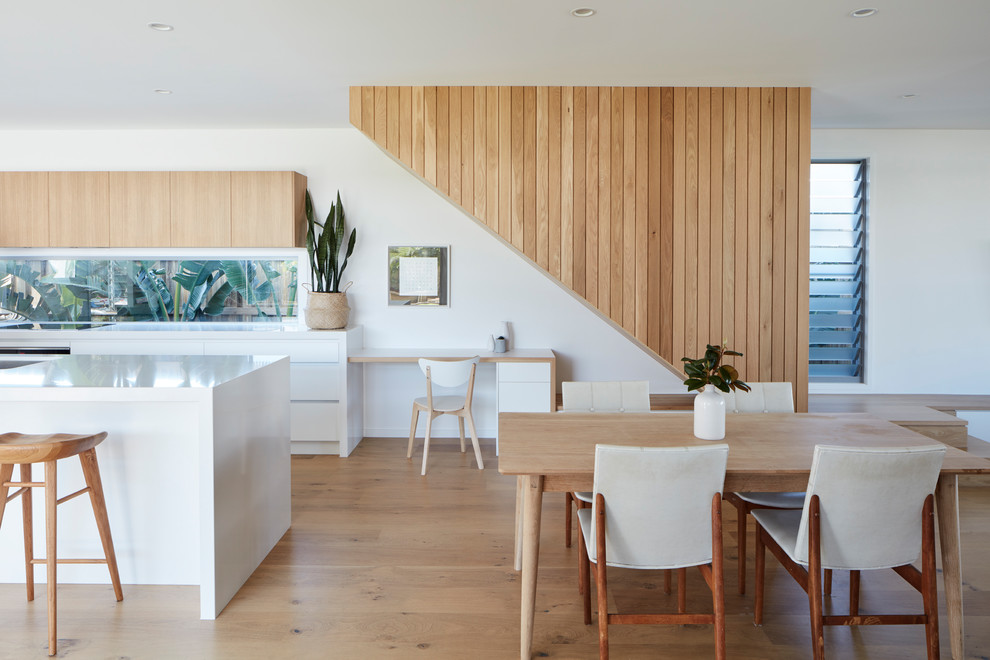 Inspiration for a contemporary kitchen/dining combo in Brisbane with white walls, light hardwood floors and beige floor.