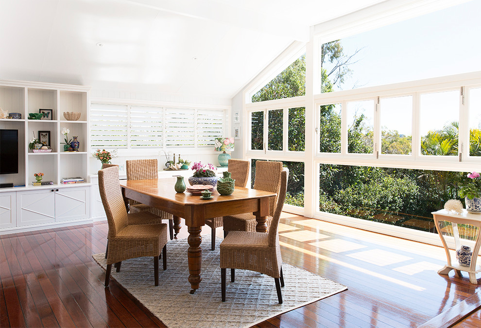 Photo of a traditional dining room in Brisbane with white walls, medium hardwood floors and brown floor.