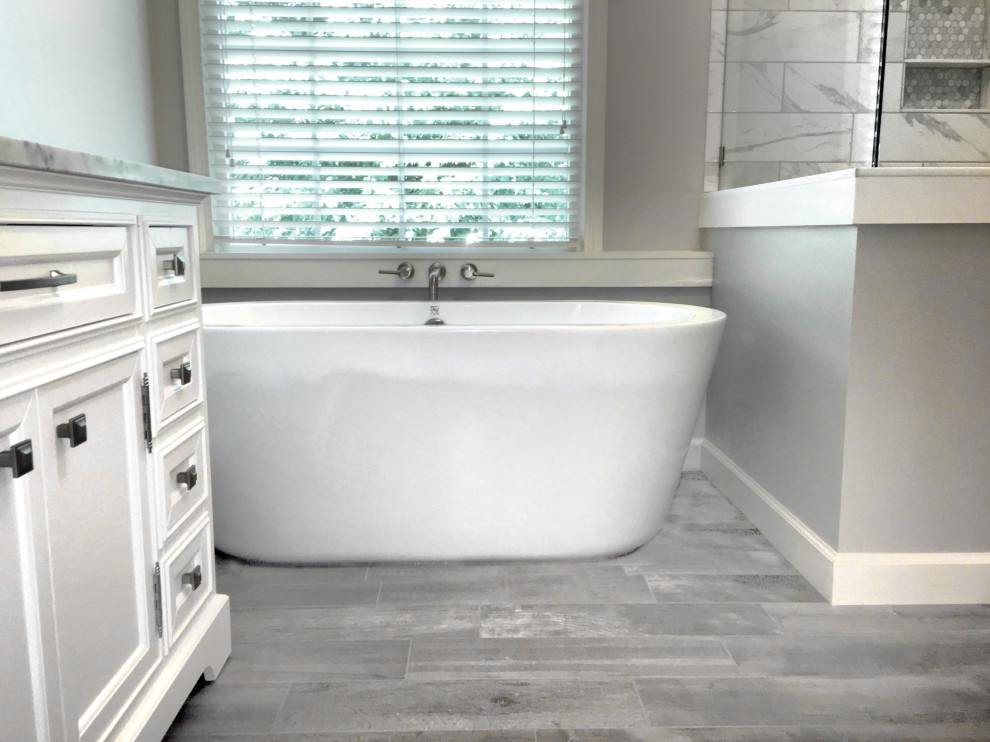 Inspiration for a large transitional master bathroom in Atlanta with shaker cabinets, white cabinets, a freestanding tub, a corner shower, a two-piece toilet, white tile, ceramic tile, grey walls, porcelain floors, an undermount sink, marble benchtops, grey floor, a hinged shower door and white benchtops.