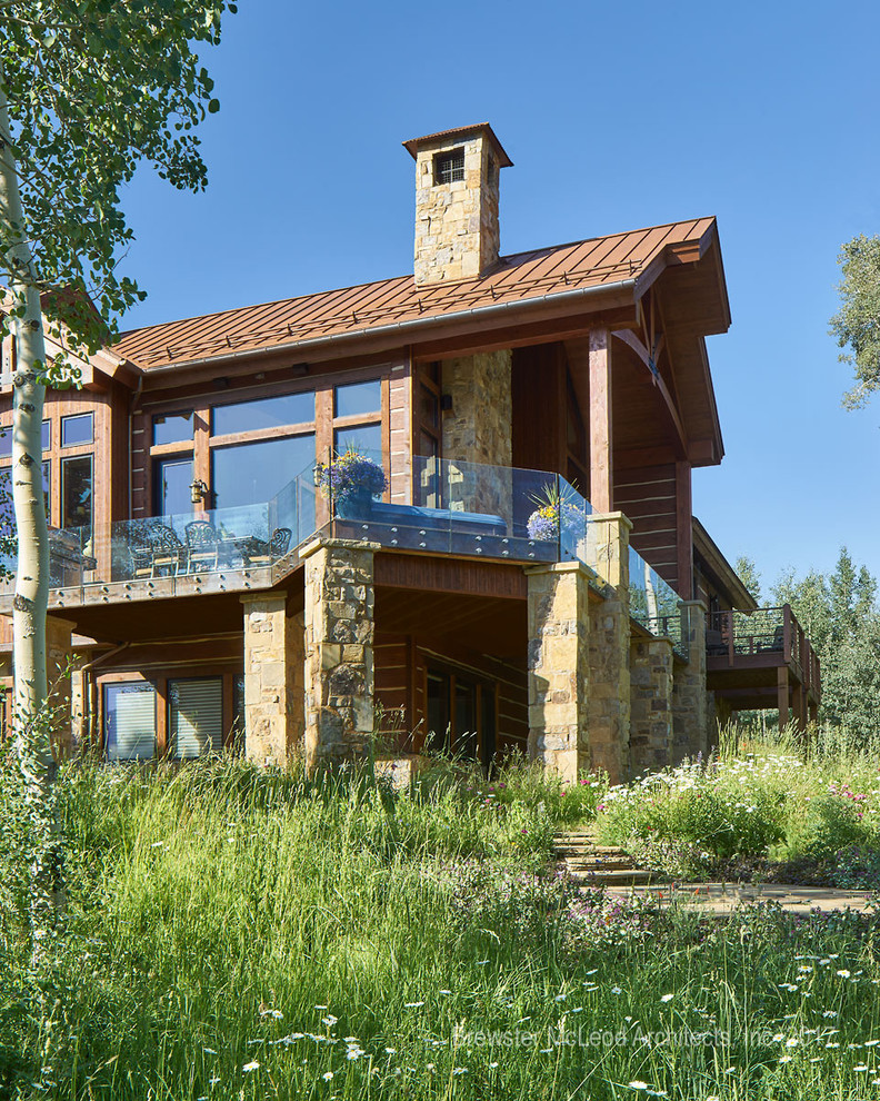 This is an example of a country brown house exterior in Denver with mixed siding.