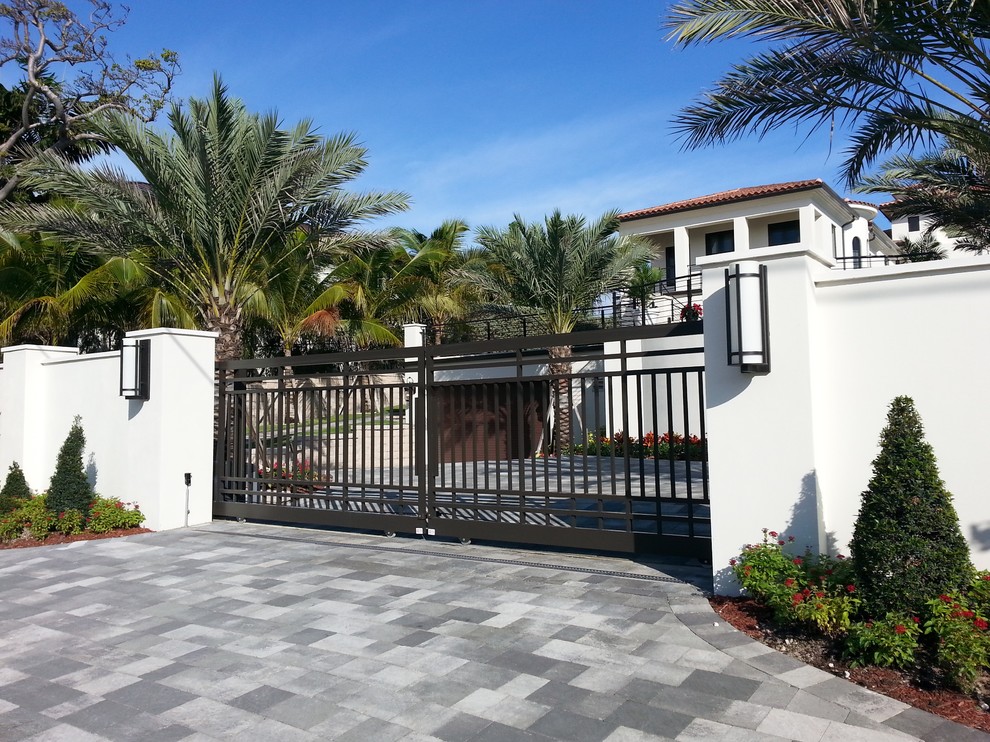 This is an example of an expansive mediterranean entryway in Miami with a double front door and a metal front door.