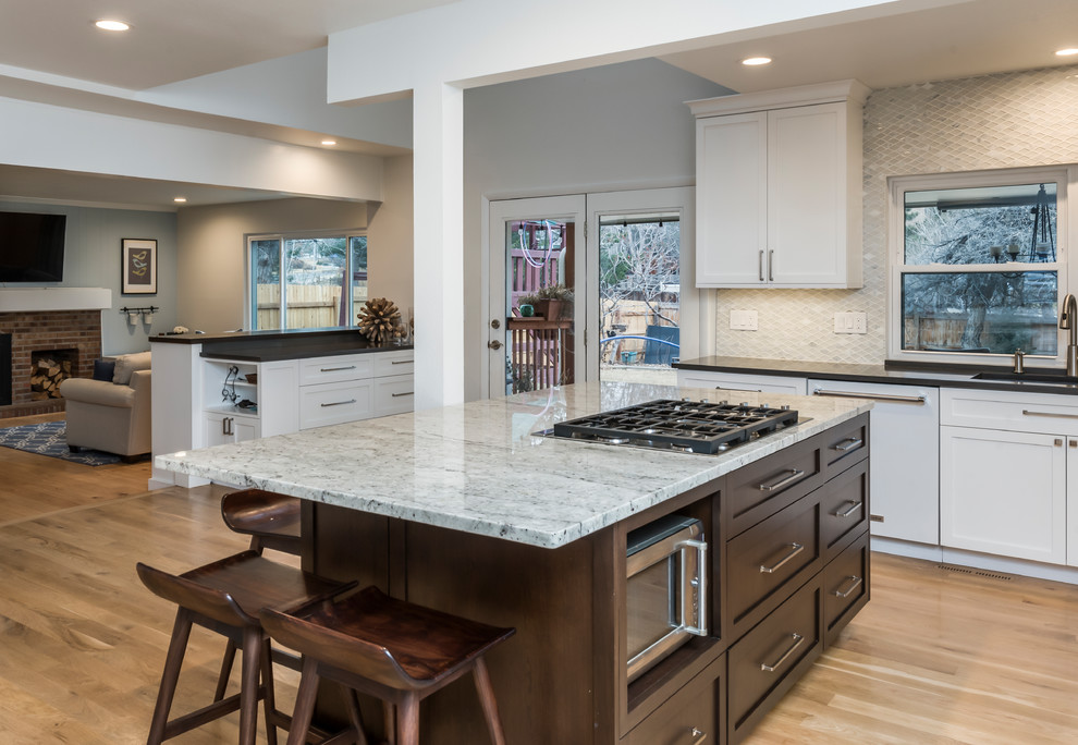 Large transitional light wood floor eat-in kitchen photo in Denver with a single-bowl sink, shaker cabinets, white cabinets, quartz countertops, white backsplash, marble backsplash, stainless steel appliances, two islands and gray countertops