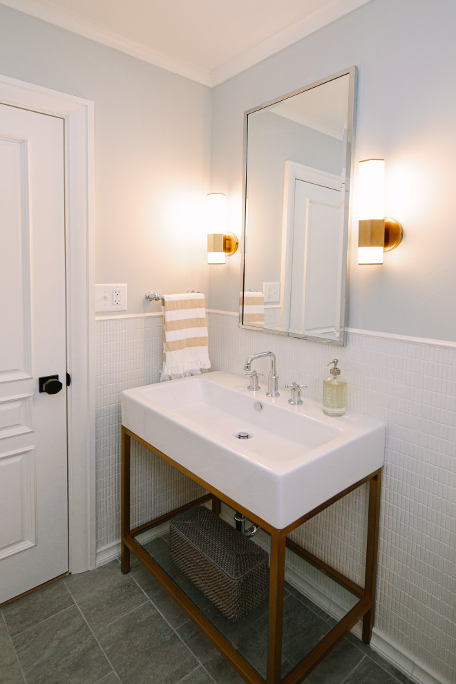 Photo of a medium sized bohemian cloakroom in Cleveland with open cabinets, white tiles, ceramic tiles, grey walls, porcelain flooring, a console sink, grey floors, white worktops, a freestanding vanity unit and wainscoting.