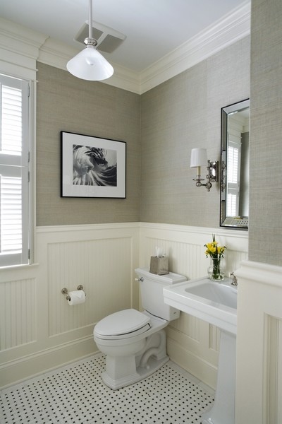 Inspiration for a mid-sized traditional powder room in Chicago with a two-piece toilet, black and white tile, beige walls, ceramic floors and a pedestal sink.