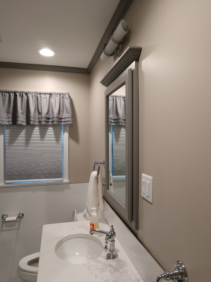 Inspiration for a small transitional home design remodel with raised-panel cabinets, gray cabinets, an undermount sink, solid surface countertops and multicolored countertops