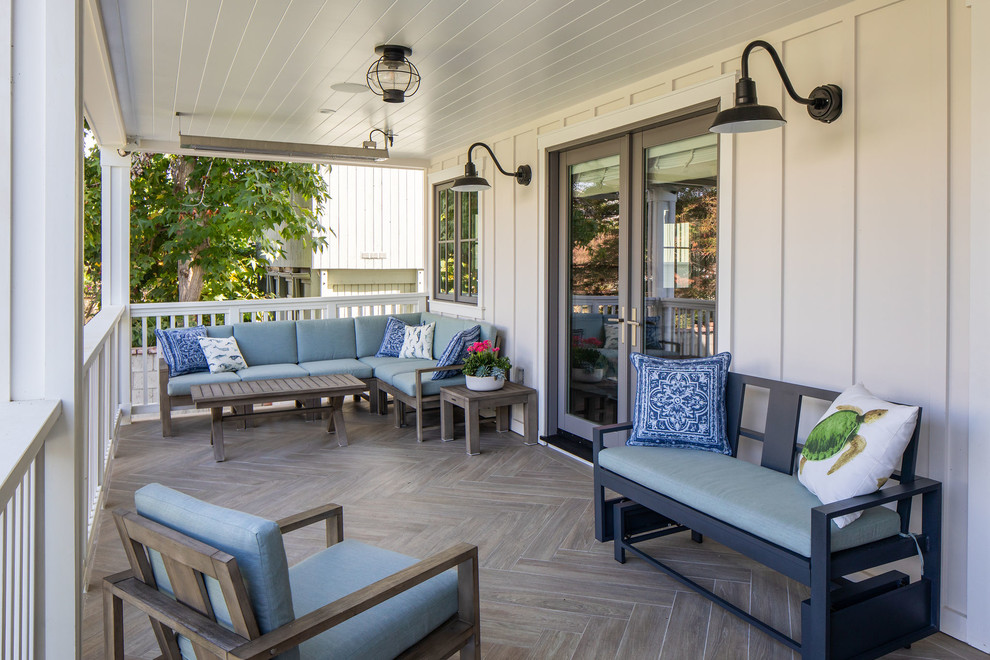 Inspiration for a beach style verandah in Los Angeles with tile and a roof extension.