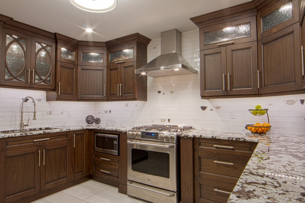 Kitchen - mid-sized transitional u-shaped kitchen idea in Toronto with shaker cabinets, white cabinets, granite countertops, gray backsplash and stainless steel appliances