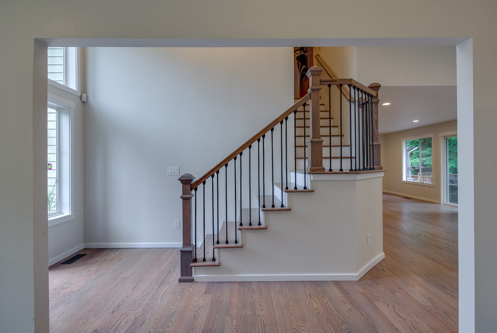 Foyer - mid-sized transitional medium tone wood floor and brown floor foyer idea in Orange County with white walls and a blue front door