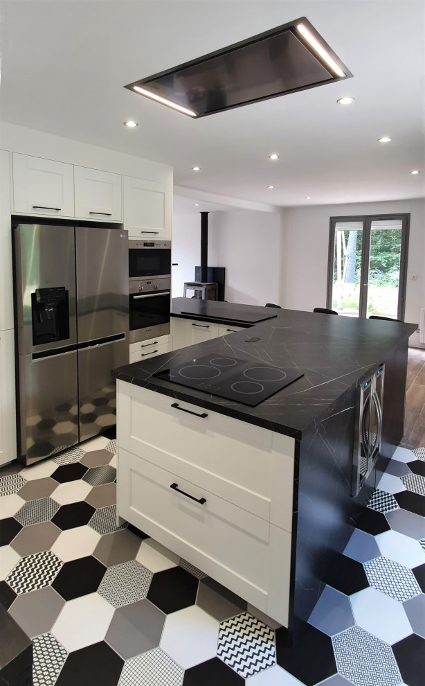 Design ideas for a large contemporary u-shaped open plan kitchen in Other with an undermount sink, flat-panel cabinets, stainless steel cabinets, granite benchtops, black splashback, granite splashback, panelled appliances, ceramic floors, with island, white floor and black benchtop.