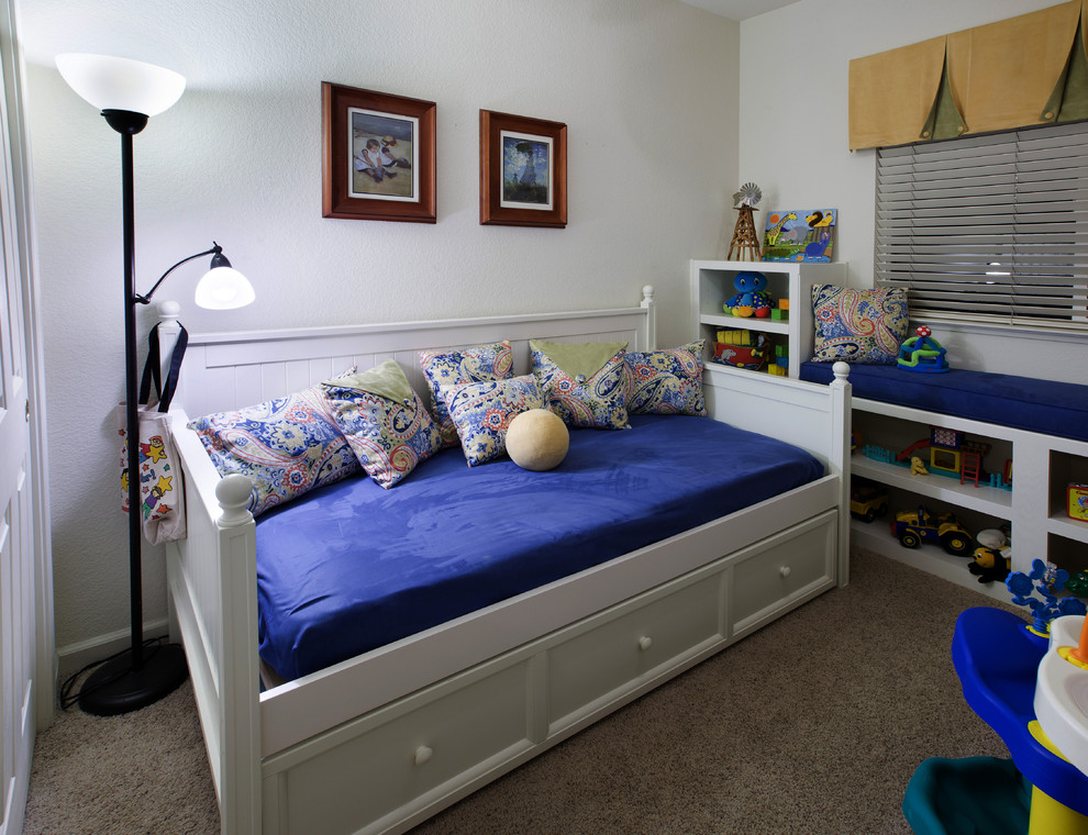 This is an example of a mid-sized contemporary gender-neutral kids' bedroom for kids 4-10 years old in Sacramento with white walls and carpet.